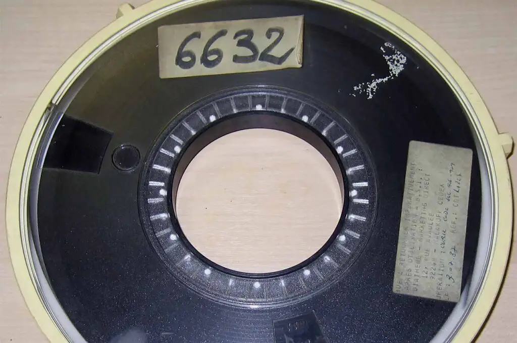 A large roll of magnetic tape in protective casing.