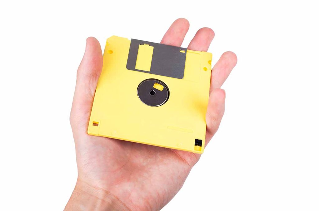 A simple yellow floppy disk held in hand.