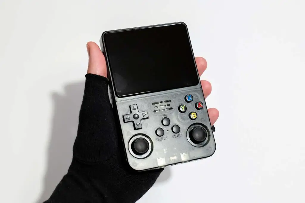 The R36S handheld emulator retro console held in hand.