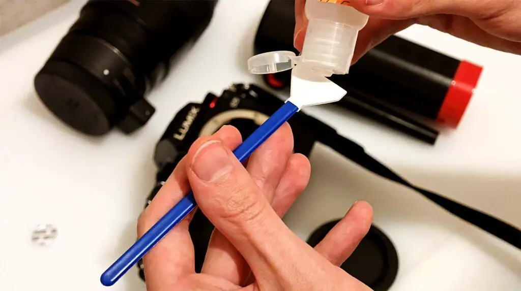 Applying the sensor cleaning solution on the swab.