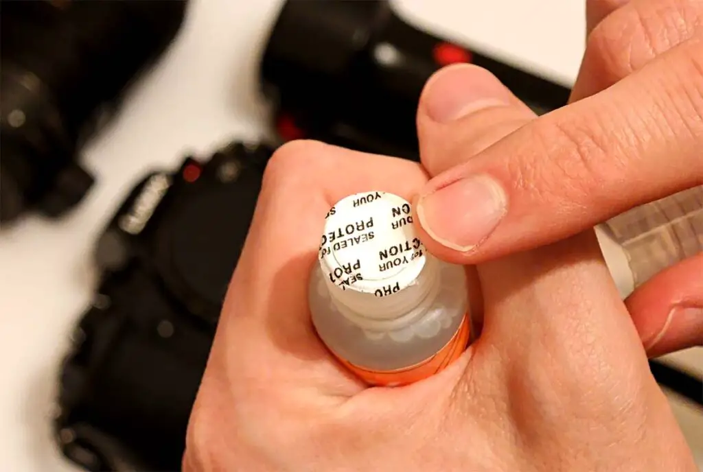 The protective cap on top of the sensor cleaning solution bottle.