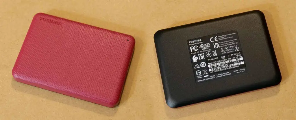 Toshiba Canvio Advance 2TB red portable hard drive - front and back view.