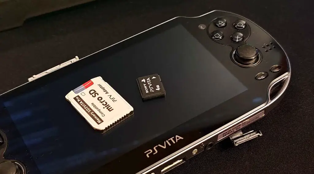 PlayStation Vita PH-1004, an SD2VITA microSD card adapter and an official Sony Vita memory card.