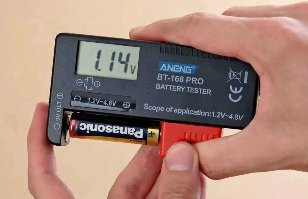 A Panasonic AA battery with the BT-168 PRO digital tester, with 1.14V shown on the display.