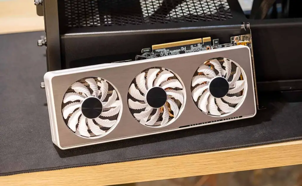 An RTX 3xxx series GPU next to an empty PC case.
