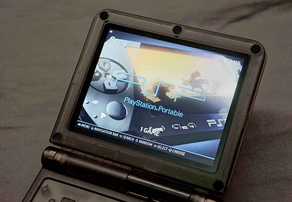 The Powkiddy V90S, with the PSP emulator game selection screen open.