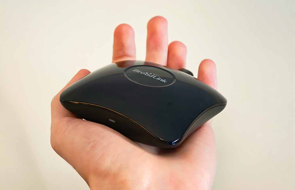 Broadlink RM4 Pro universal remote hub resting in a hand.