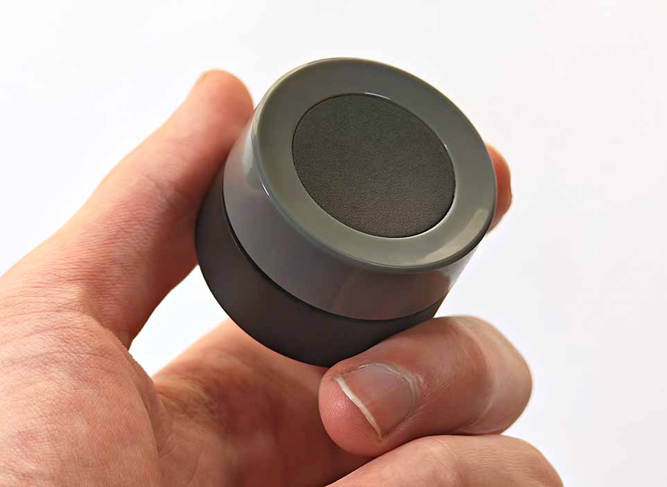 MOES Zigbee smart knob held in a hand closeup.