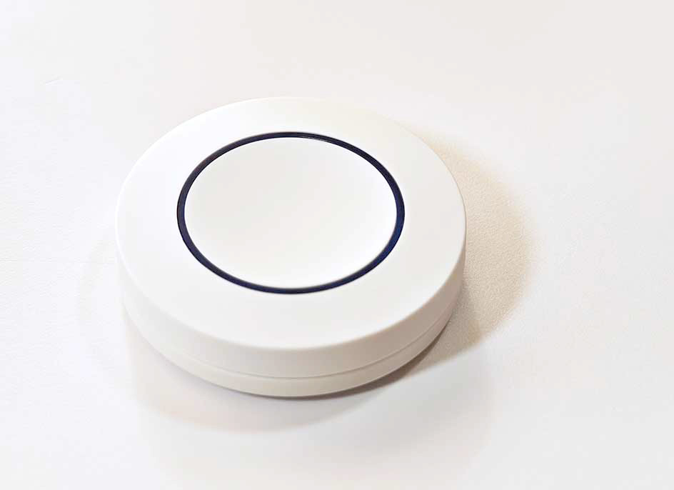 Red ZG-101ZL Zigbee smart button photographed closeup shot.