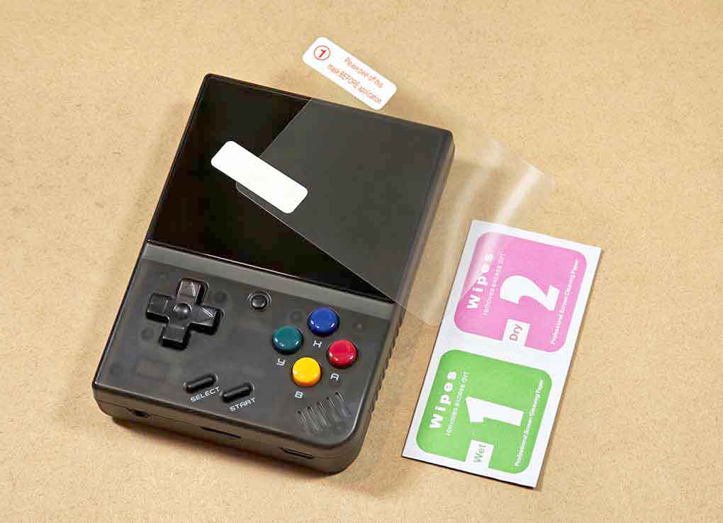 Miyoo Mini Plus and its bundled screen protector and application wipes.