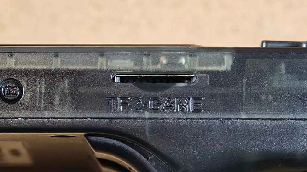 Close-up of the R36S TF2-GAME microSD card slot on the side of the handheld.