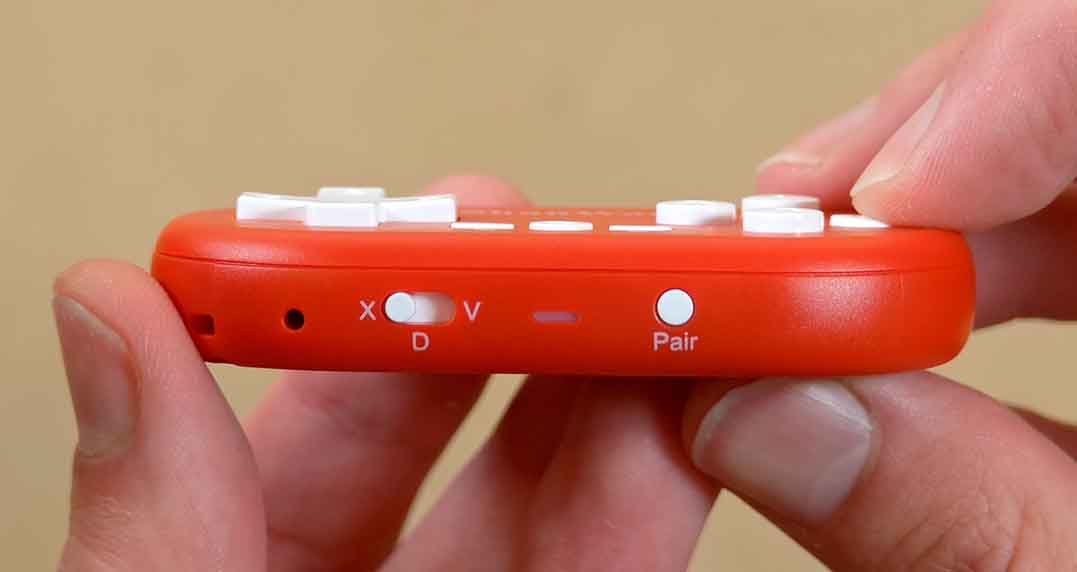 Close-up of the ShanWan Q36 button being pressed to show button travel depth.