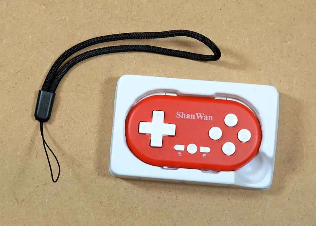 ShanWan Q36 controller, wrist strap and box insert.