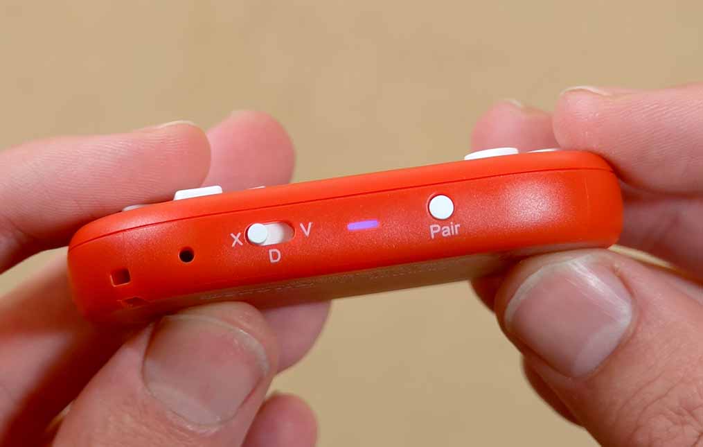 ShanWan Q36 bottom edge with X/D/V mode switch, status LED and Pair button.
