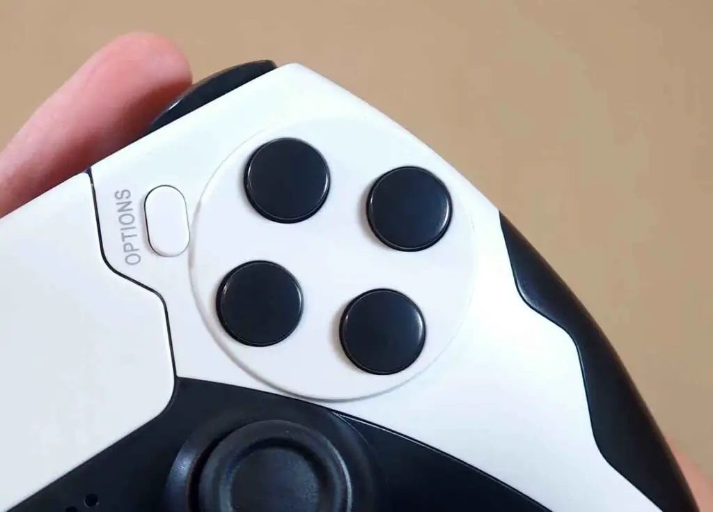 Close-up of the blank black face buttons and options button on the controller.