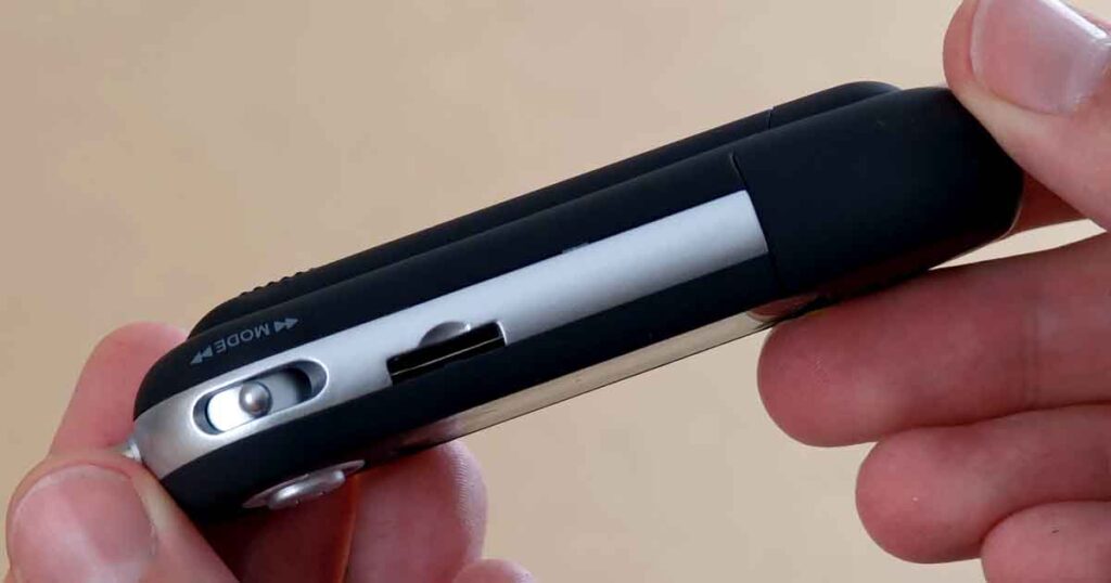 Side view of the MA933A-style MP3 player clone showing the mode button and microSD card slot.