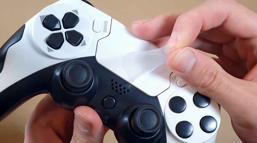 Removing the protective film from the GAMINJA P48 touchpad.