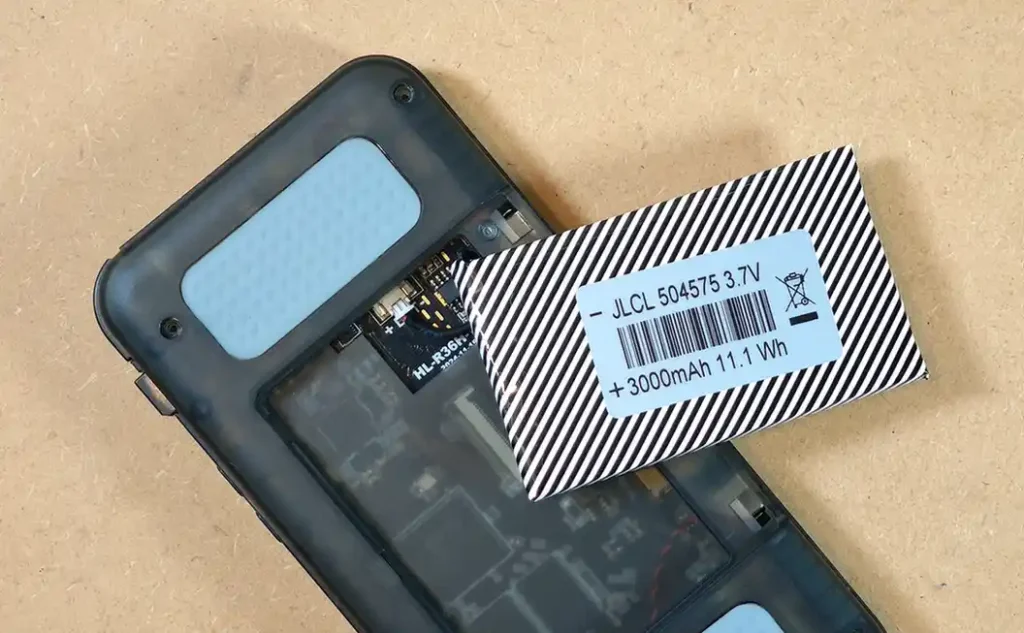 R36H battery partially lifted from the battery compartment before disconnecting the cable.