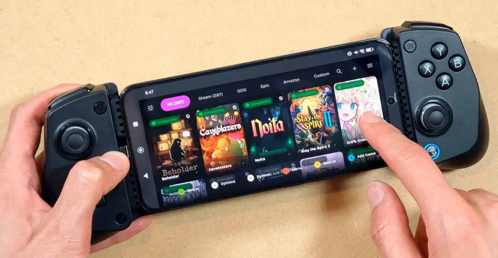 Xiaomi 14 with a telescopic controller attached and GameNative with an open Steam library view.