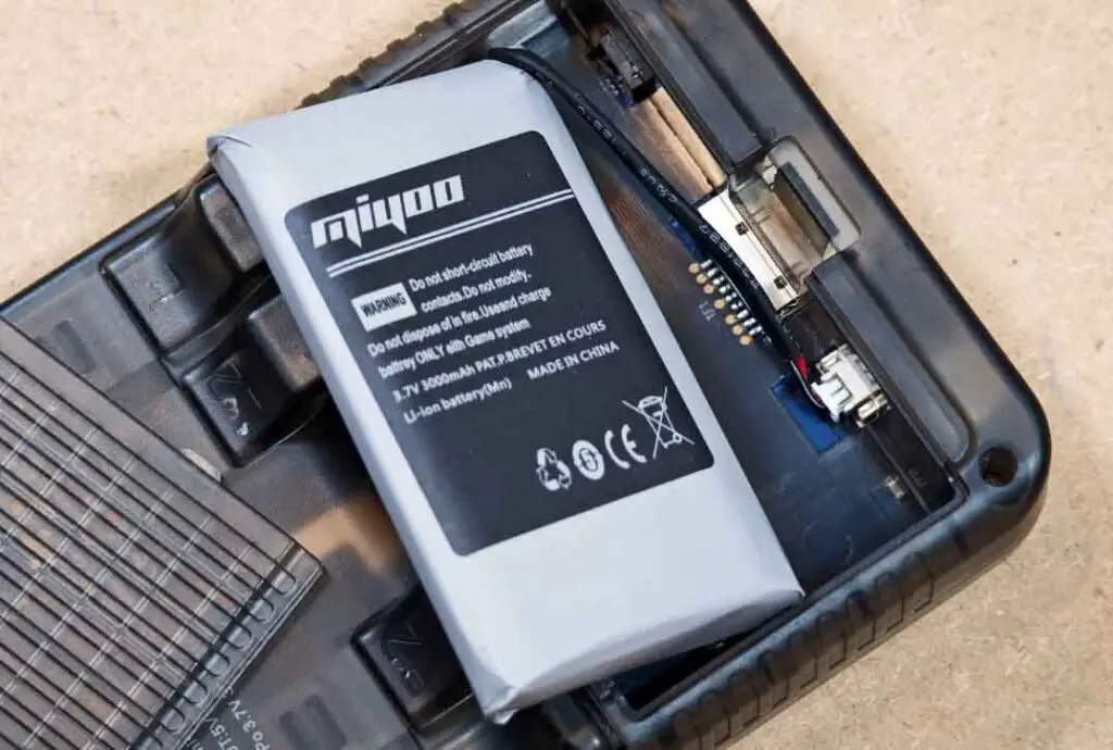 Replaceable Miyoo Mini Plus battery, back of the handheld with cover removed.