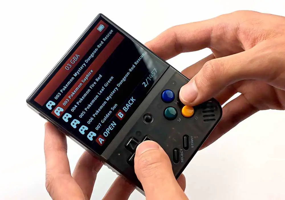 The Miyoo Mini Plus retro handheld showing an open Game Boy Advance games list on stock firmware.