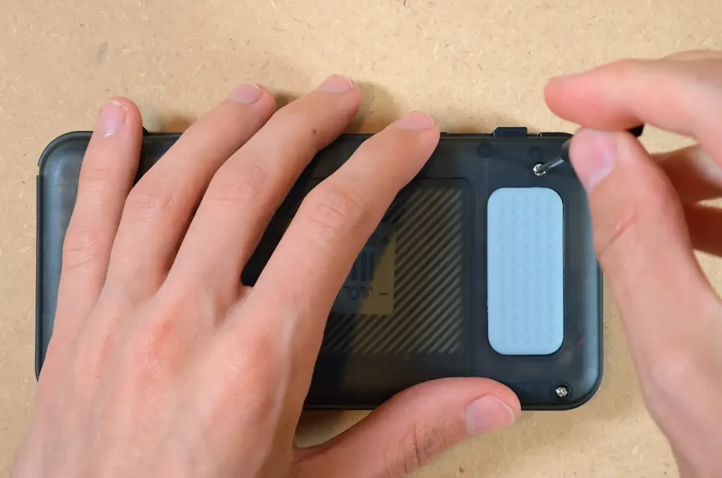 Removing the rear screws from the R36H handheld shell.