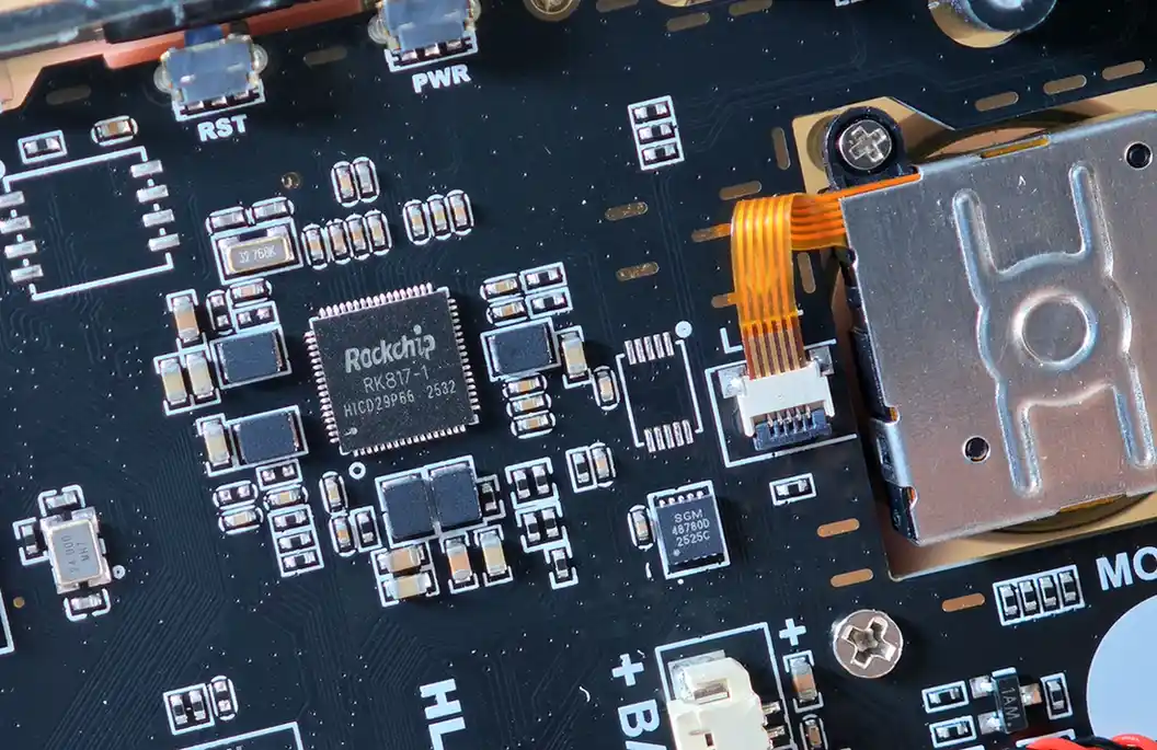 Close-up of the Rockchip RK817-1 PMIC area and analog stick ribbon cable.