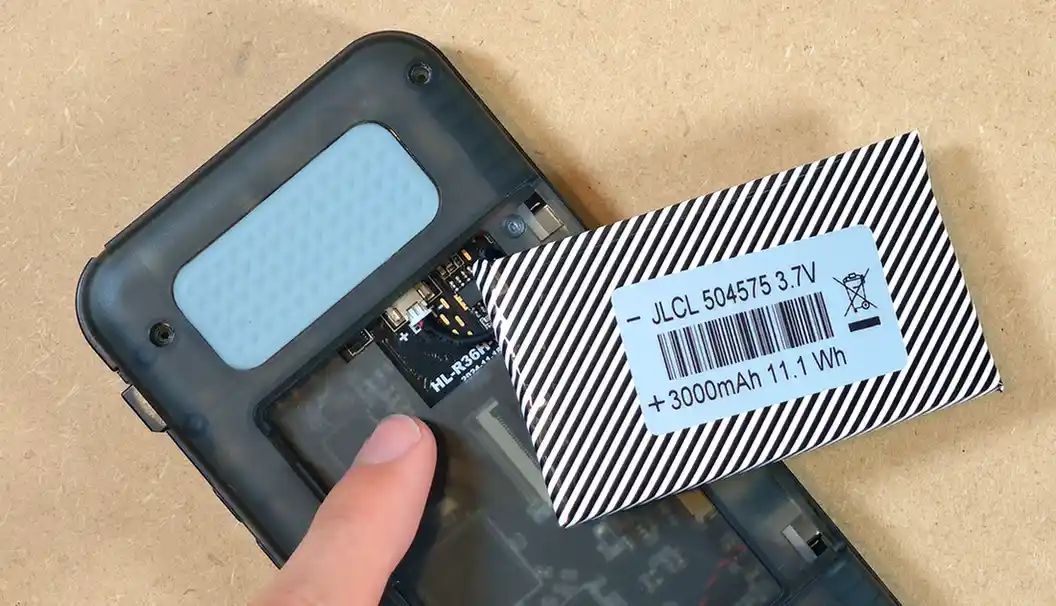 Close-up of the R36H battery cable with its small 2-pin JST connector next to the open battery compartment.