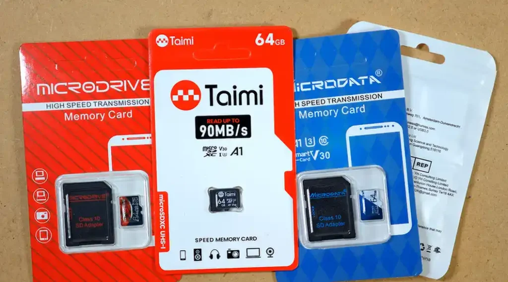 Taimi, Microdrive, Microdata and Jaster 64GB microSD cards in their retail packaging.