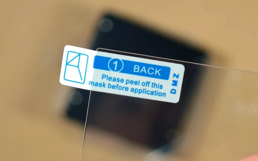 The backing tab on the RG Rotate screen protector before peeling.