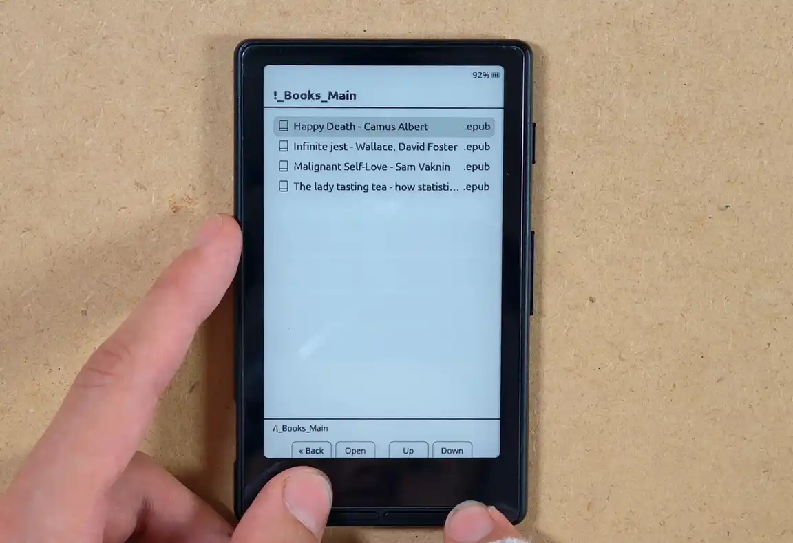 The CrossPoint firmware folder view showing a few uploaded .epub files.
