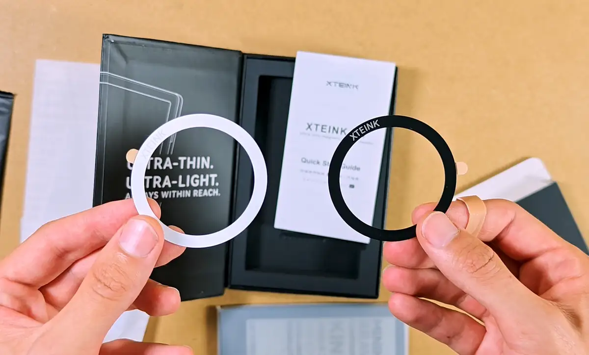 White and black MagSafe style adhesive rings included with the Xteink X4.