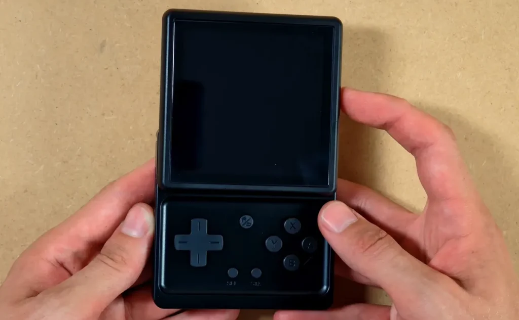 The Anbernic RG Rotate opened with the display above the physical controls.