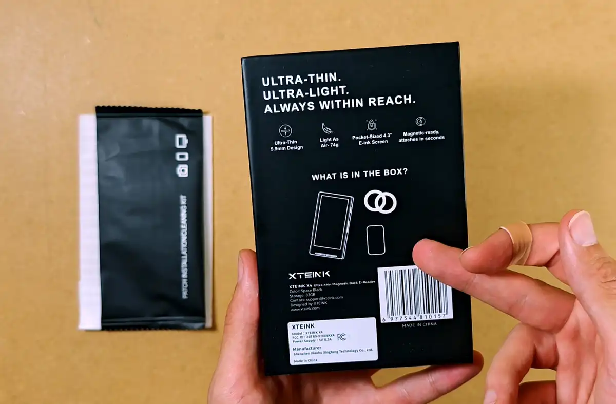 Back of the Xteink X4 with branding, regulatory text, and a flat magnetic surface.