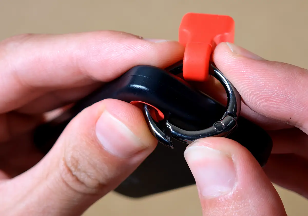 Opening the removable ring attachment on the cable holder.