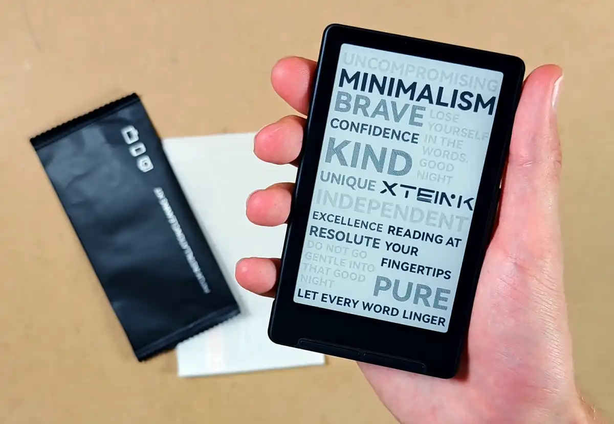 Xteink X4 e-reader unboxed and held in hand.