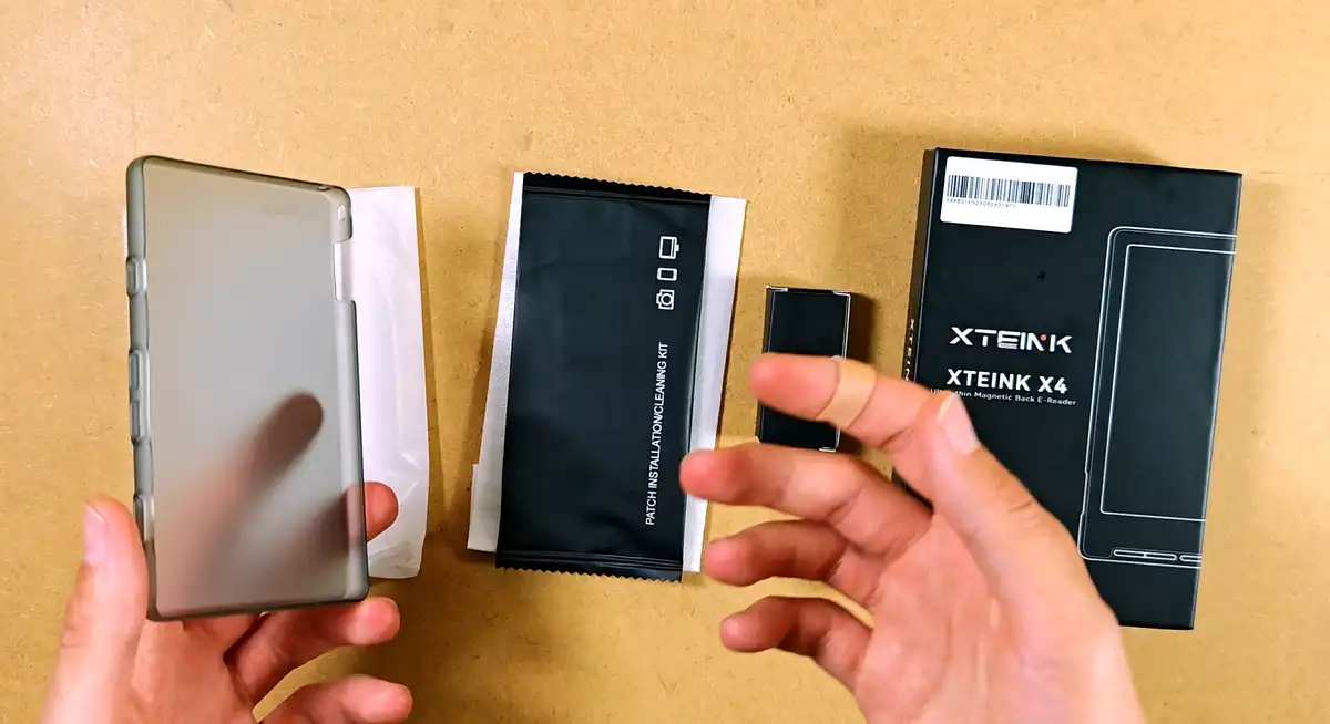 Xteink X4, protective case, accessories, and packaging arranged on a table.