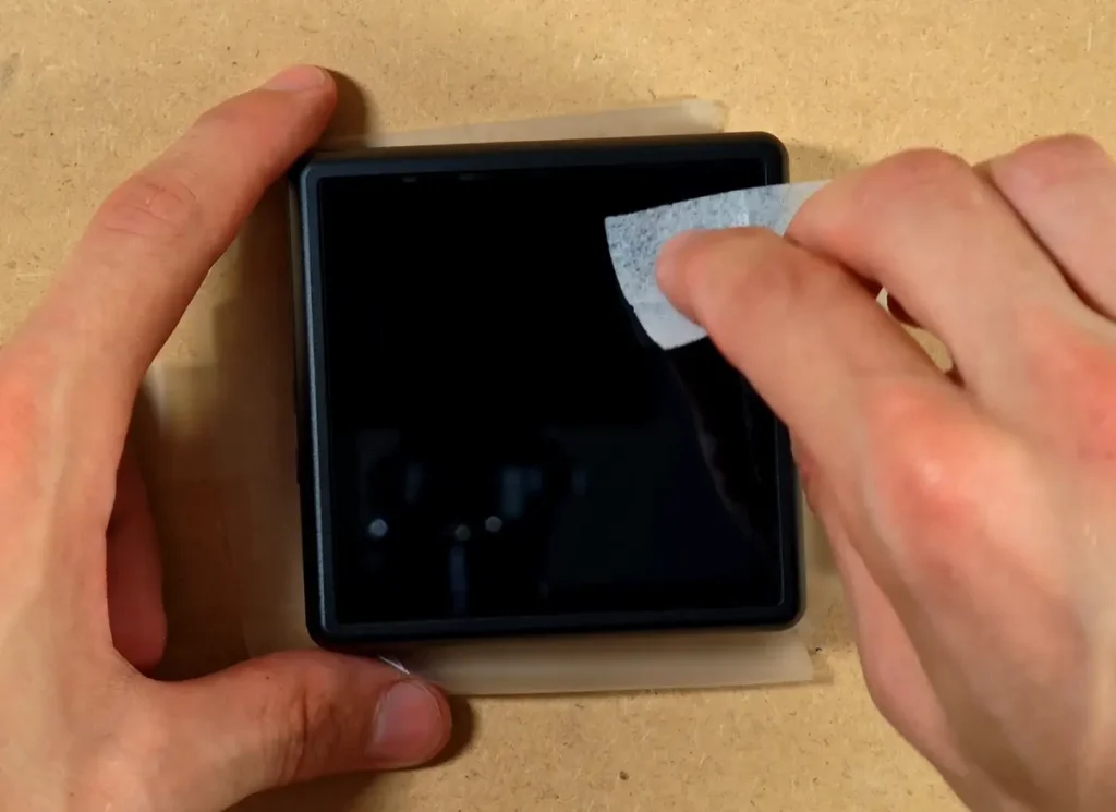 Cleaning the RG Rotate display before installing the screen protector.