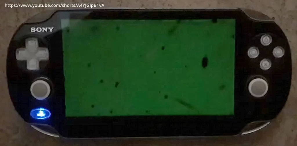 The black mura spots visible across an original OLED PS Vita display.