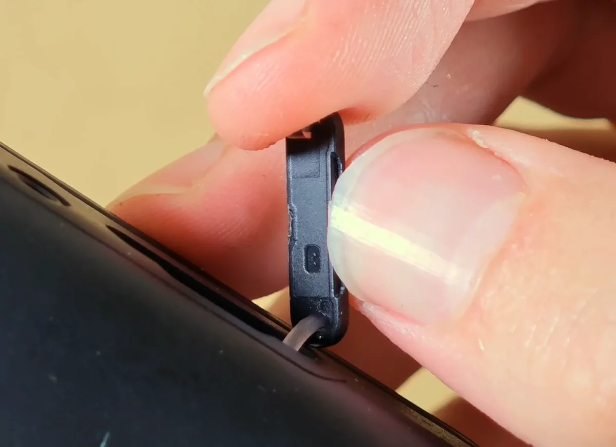 Opening the protective microSD slot door on the AYN Thor.
