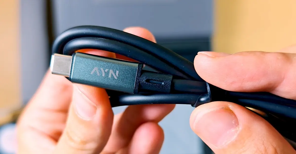 A branded USB-C to USB-C charging cable included with the AYN Thor.